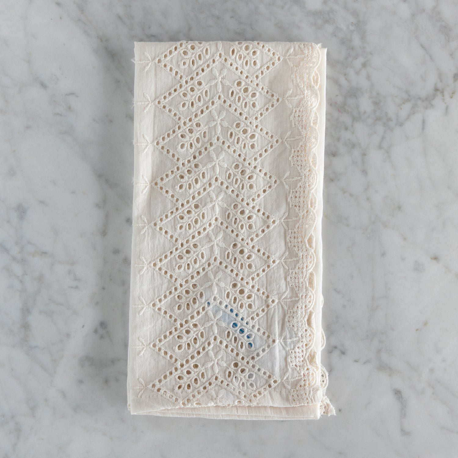Lace fabric napkin on a marble surface.