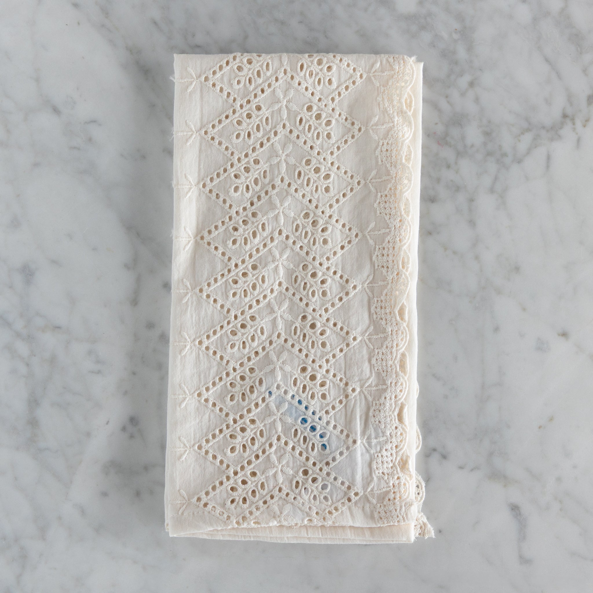 Lace fabric napkin on a marble surface.