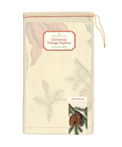 The Christmas Botanica Vintage Napkins packaged in a hand-sewn, drawstring muslin bag with the signature Cavallini sticker that reads &quot;Christmas Vintage Napkins&quot; and an image of pinecones with the words &quot;Botanica&quot; above it in red.