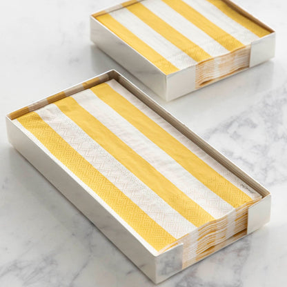 Two Silver Napkin Holders, guest-sized and cocktail-sized, containing yellow and white napkins on a white table.