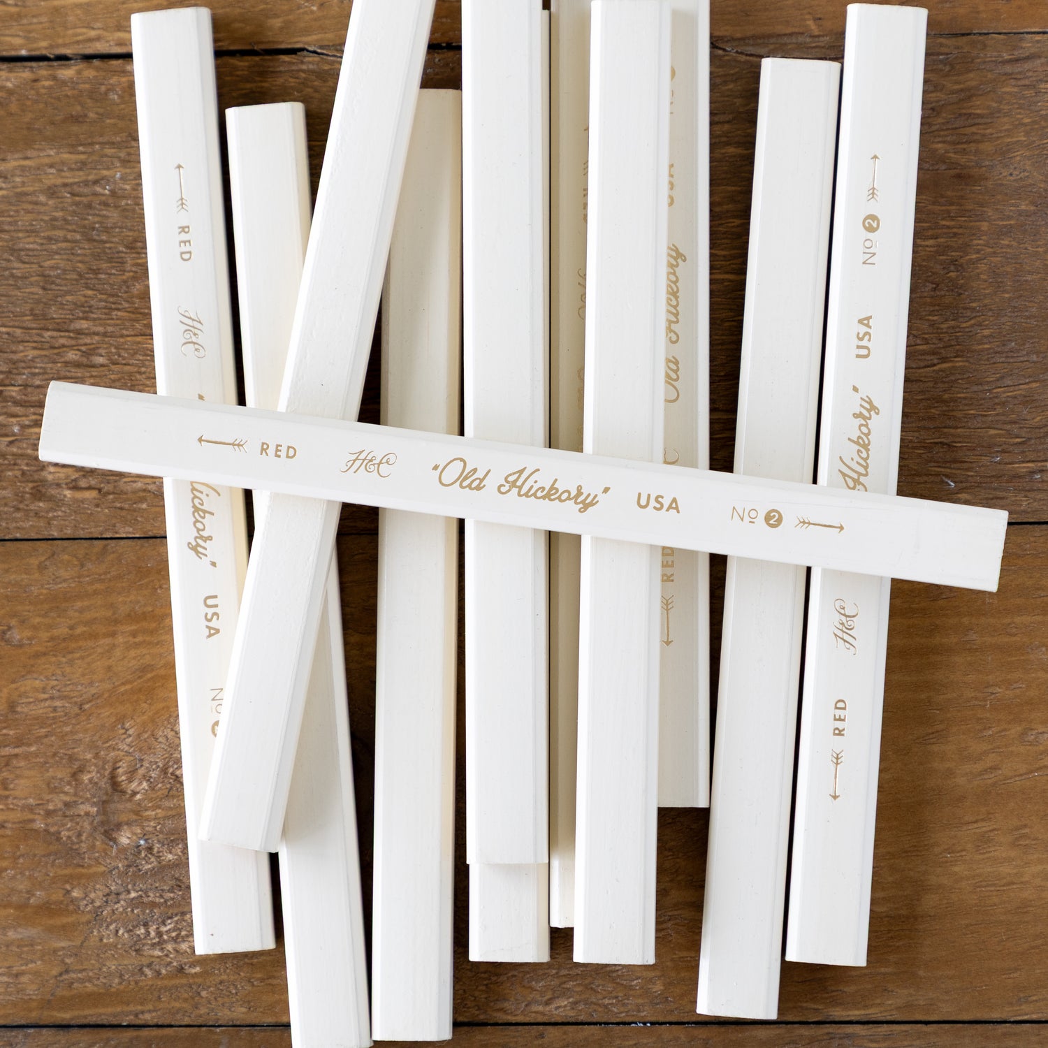 Group of Old Hickory Carpenter Pencils on a wood surface. 
