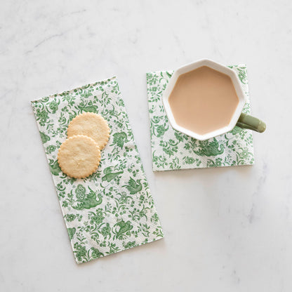 A cup of coffee and cookies on a white table adorned with Hester &amp; Cook&