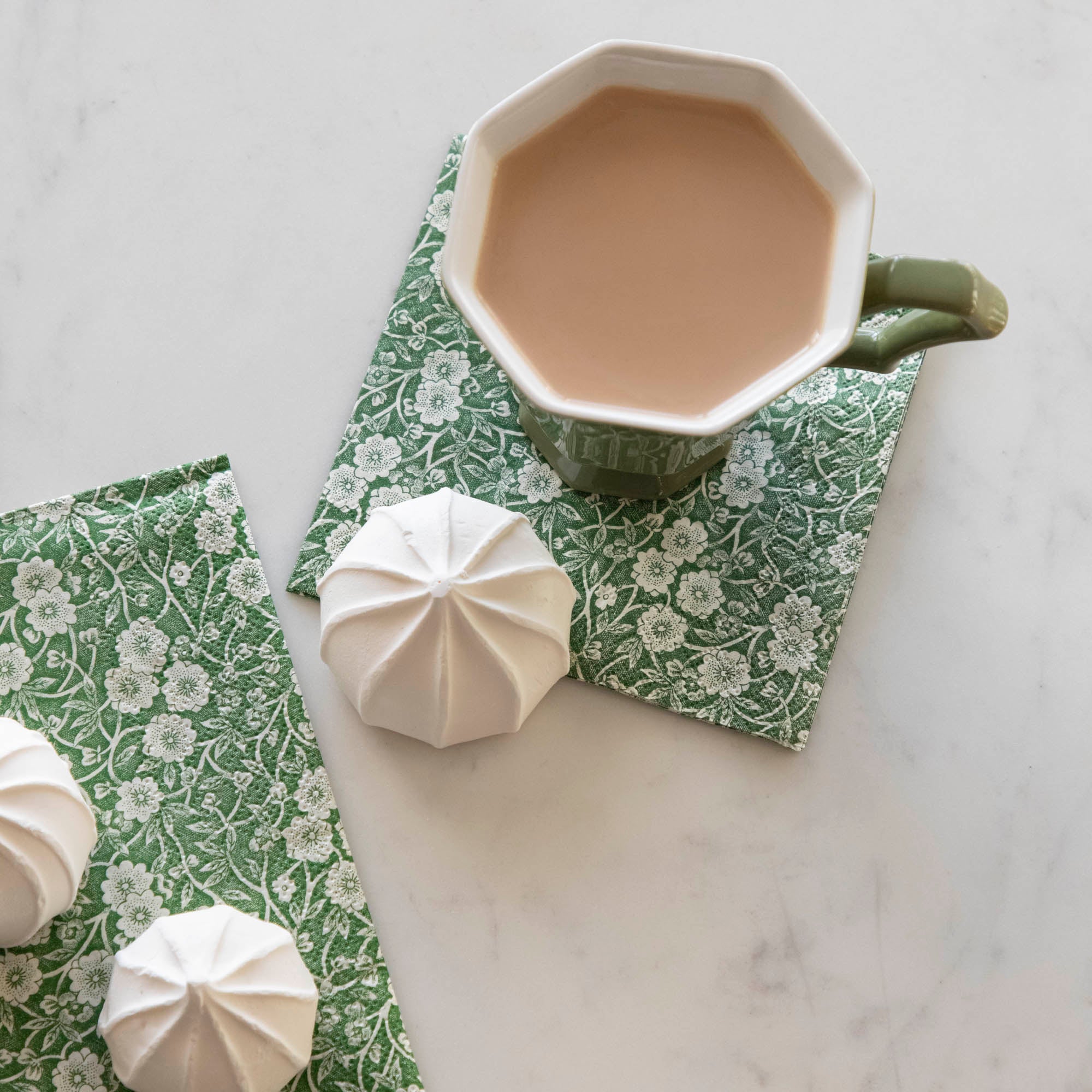 A cup of tea on a Green Calico Napkin from Hester &amp; Cook, creating a serene table setting.