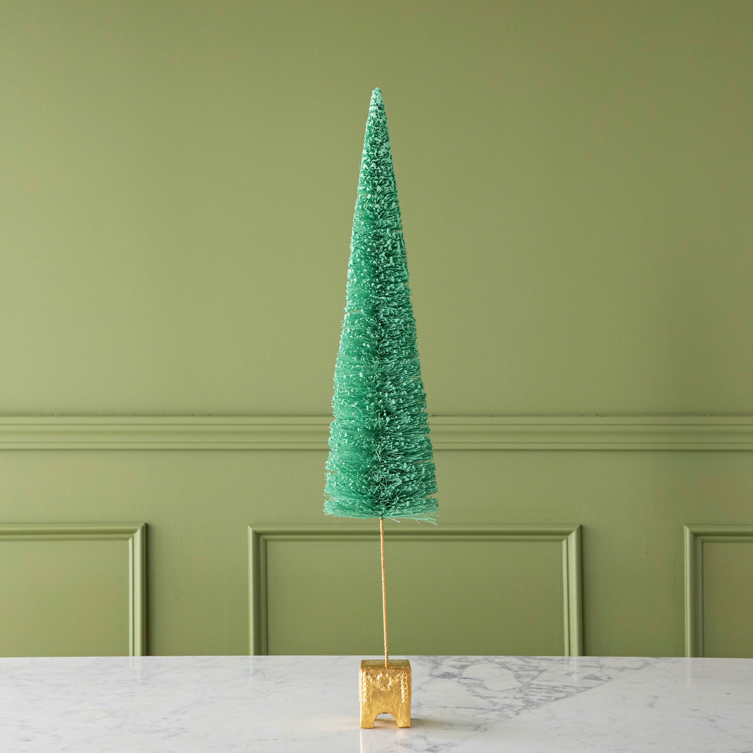 A 29&quot; Green French Forest Sisal Tree with a gold base, on a marble table.