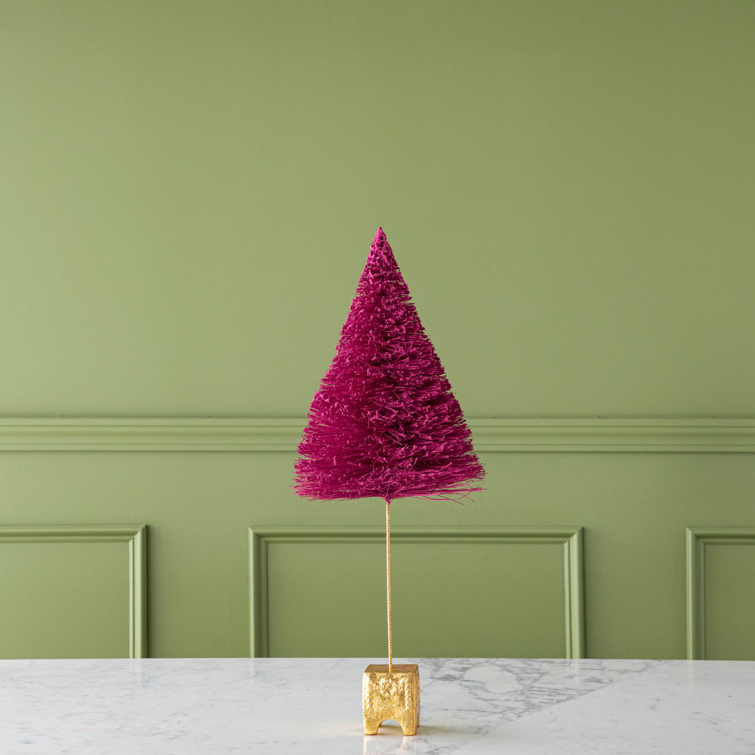 A 22&quot; Magenta French Forest Sisal Tree with a gold base, on a marble table.