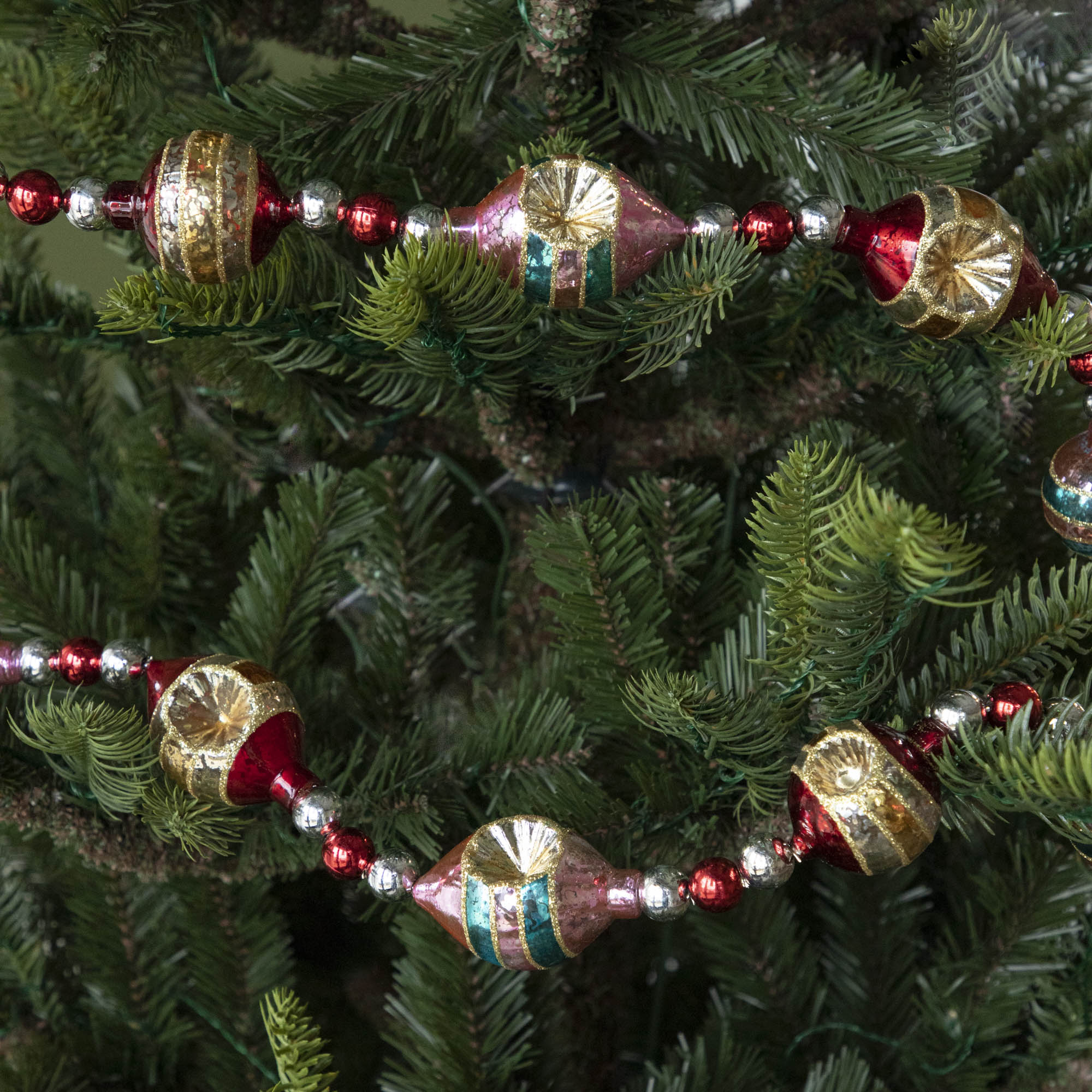 Retro Tinsel and Glass Finial Garland strung on a tree.