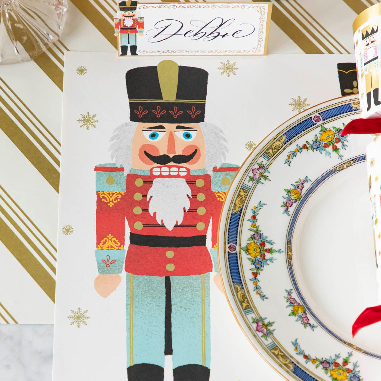 Nutcracker Placemat under a plate and on top of the Gold Peppermint Stripe Runner.