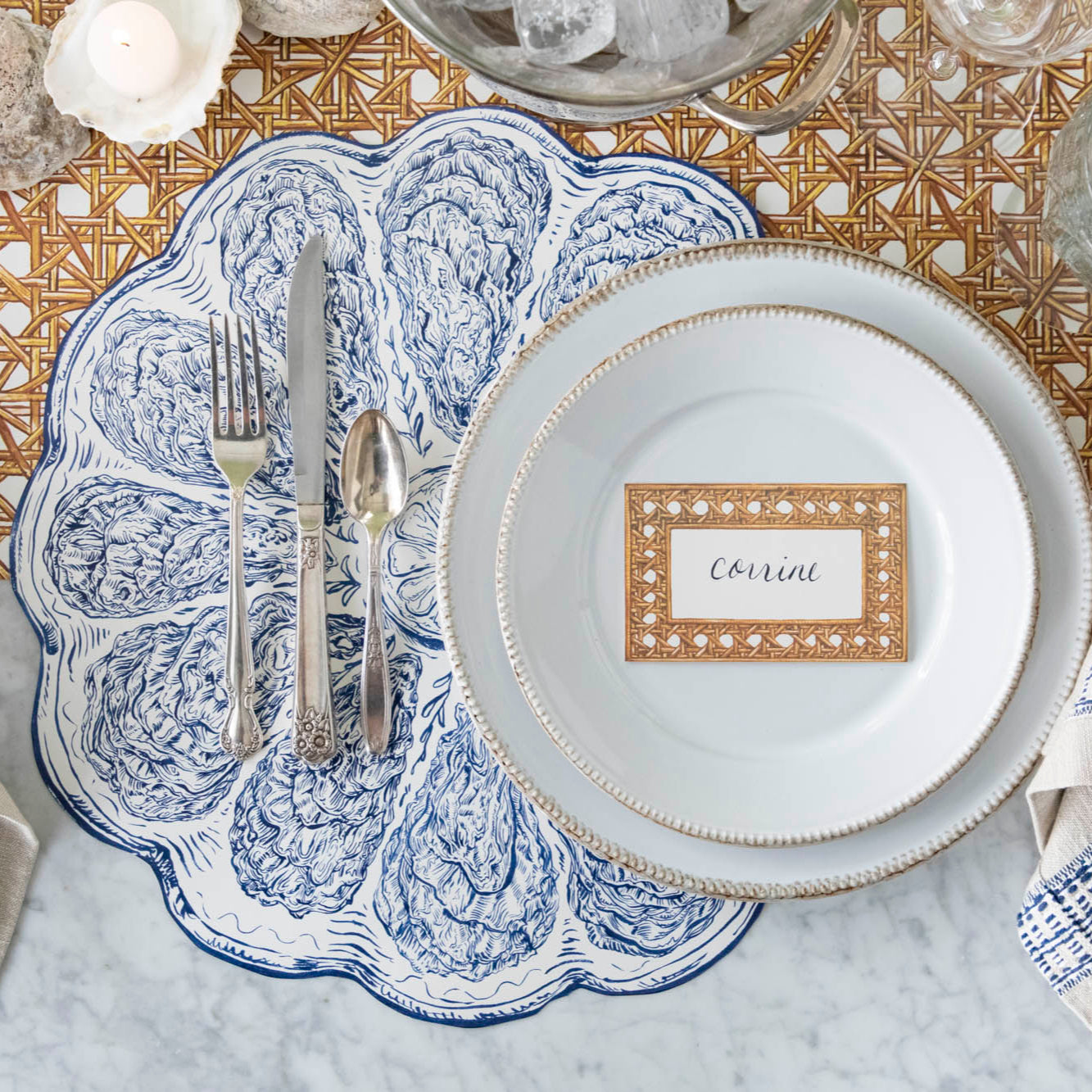 Rattan Weave Place Card with &quot;Corrine&quot; written on it, on a nautical themed table setting.