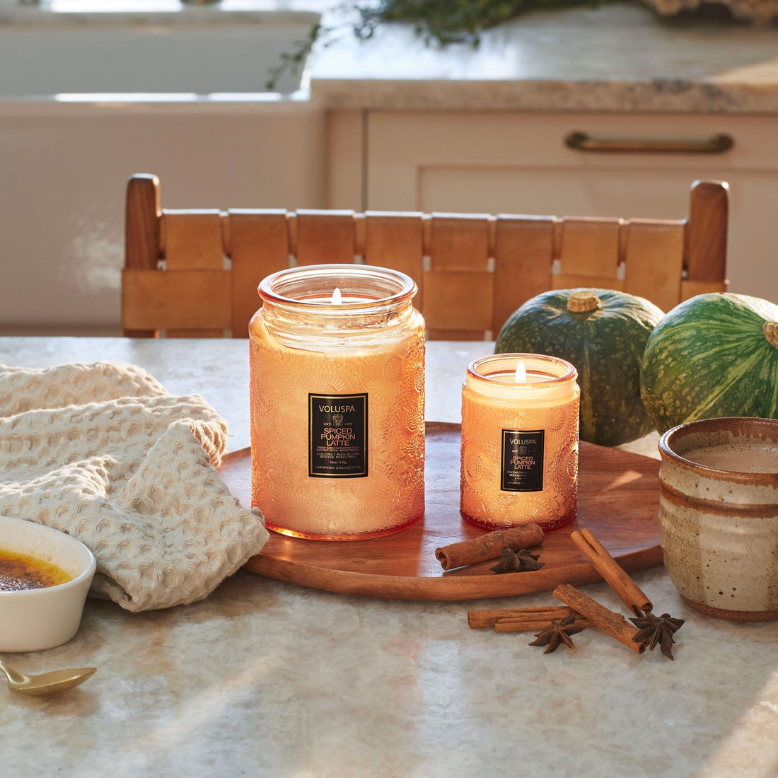 Table with two Spiced Pumpkin Latte candles lit