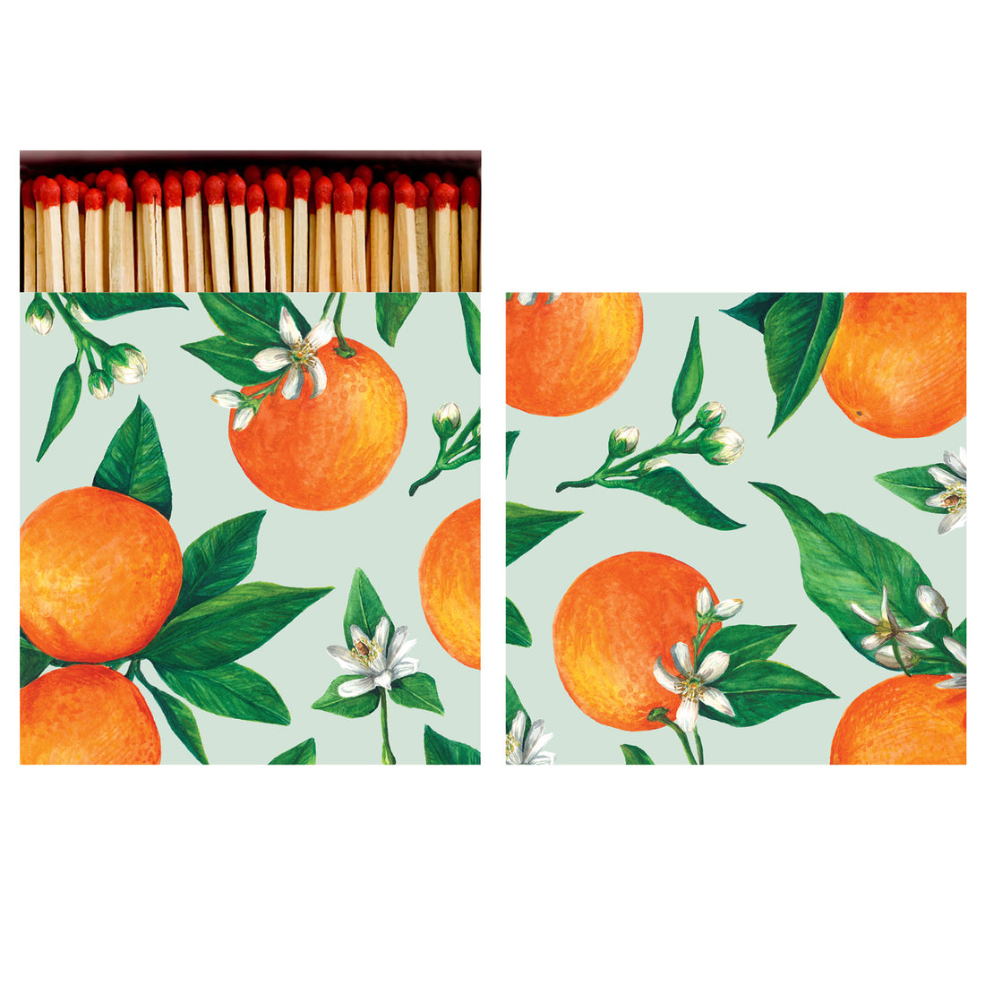 Two sides of a square match box, the left of which is open slightly to reveal the matches inside. The artwork on the box depicts vibrant oranges with deep green leaves and white blossoms scattered over a seafoam background.