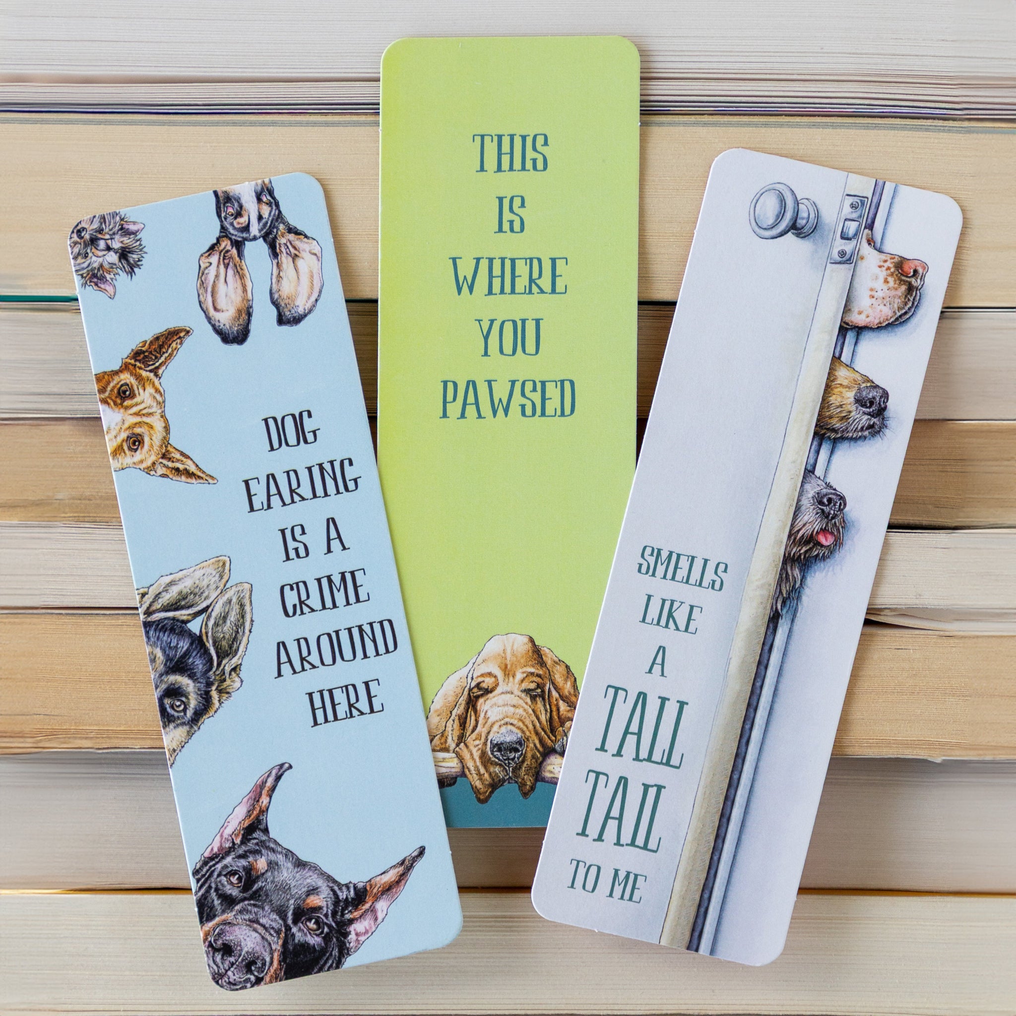 Dog Tales Bookmarks Set of 3 on stacks of books.