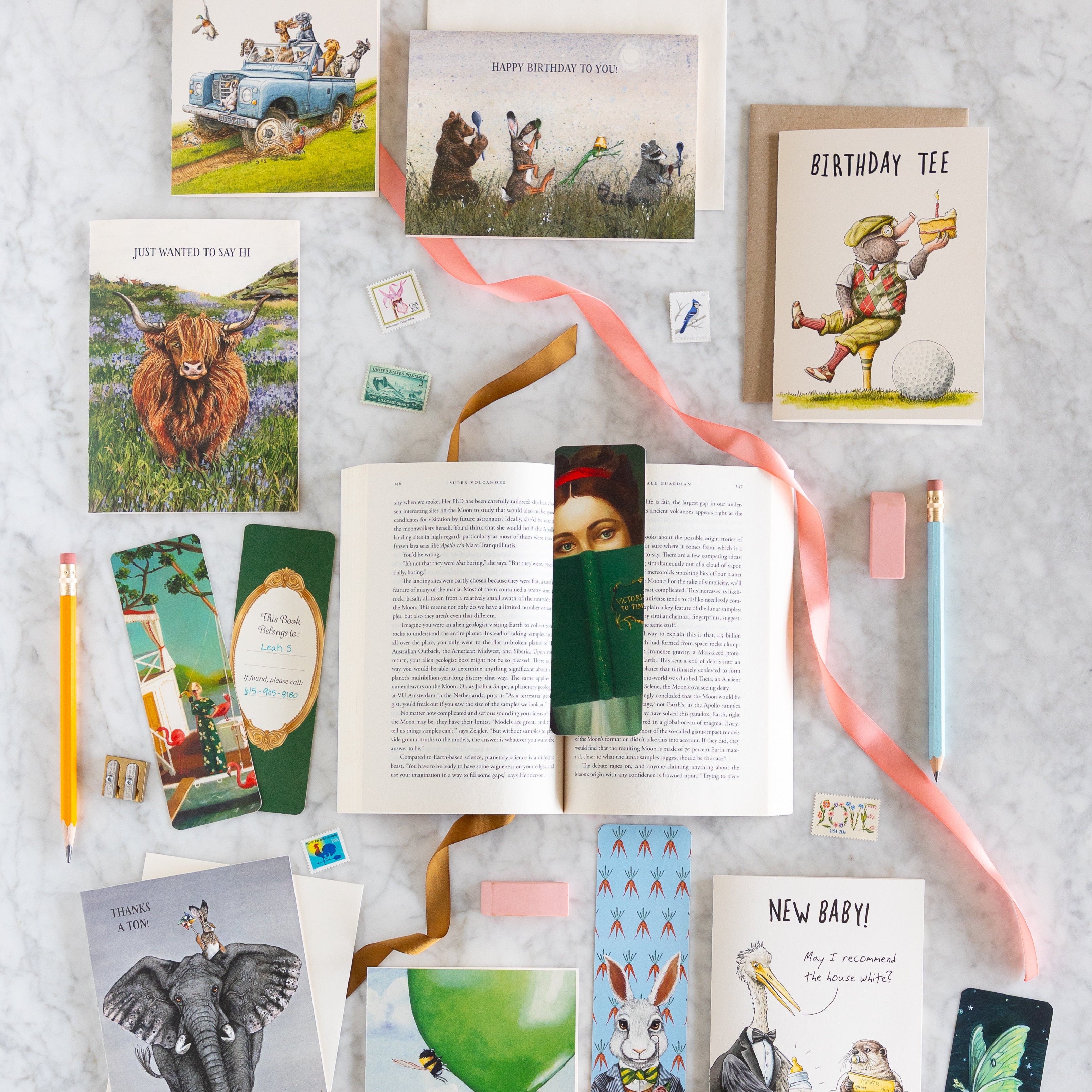 Collection of greeting cards and stationery items on a marble table.