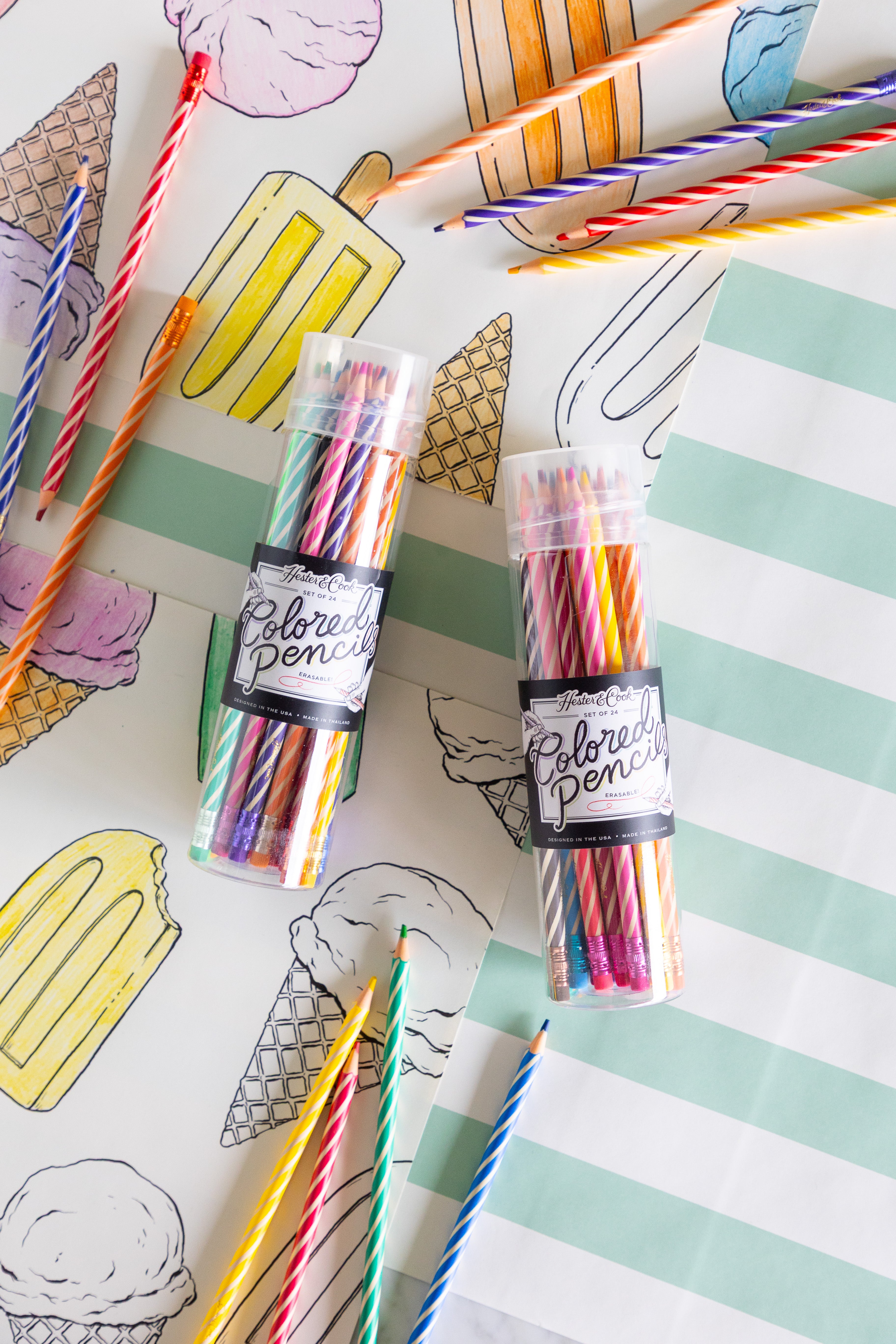 Two tubes of colored pencils on a coloring placemat with ice cream cones.