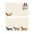 Stationery with dog illustrations on them.  The top has a dog on the top and bottom of the card peering out and the bottom has a row of dogs walking. 