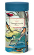 A cylindrical packaging of a Audubon bird puzzle with vintage illustrations. The box is predominantly blue and green with images of various birds, branches, and a label that reads &