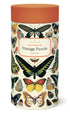 Cylindrical puzzle box with images of vintage butterflies on it by Cavallini Papers. 
