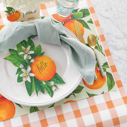 An elegant, citrus themed table setting featuring the Orange Painted Check Runner paired with Orange Orchard Placemat and Orange Table Accent.