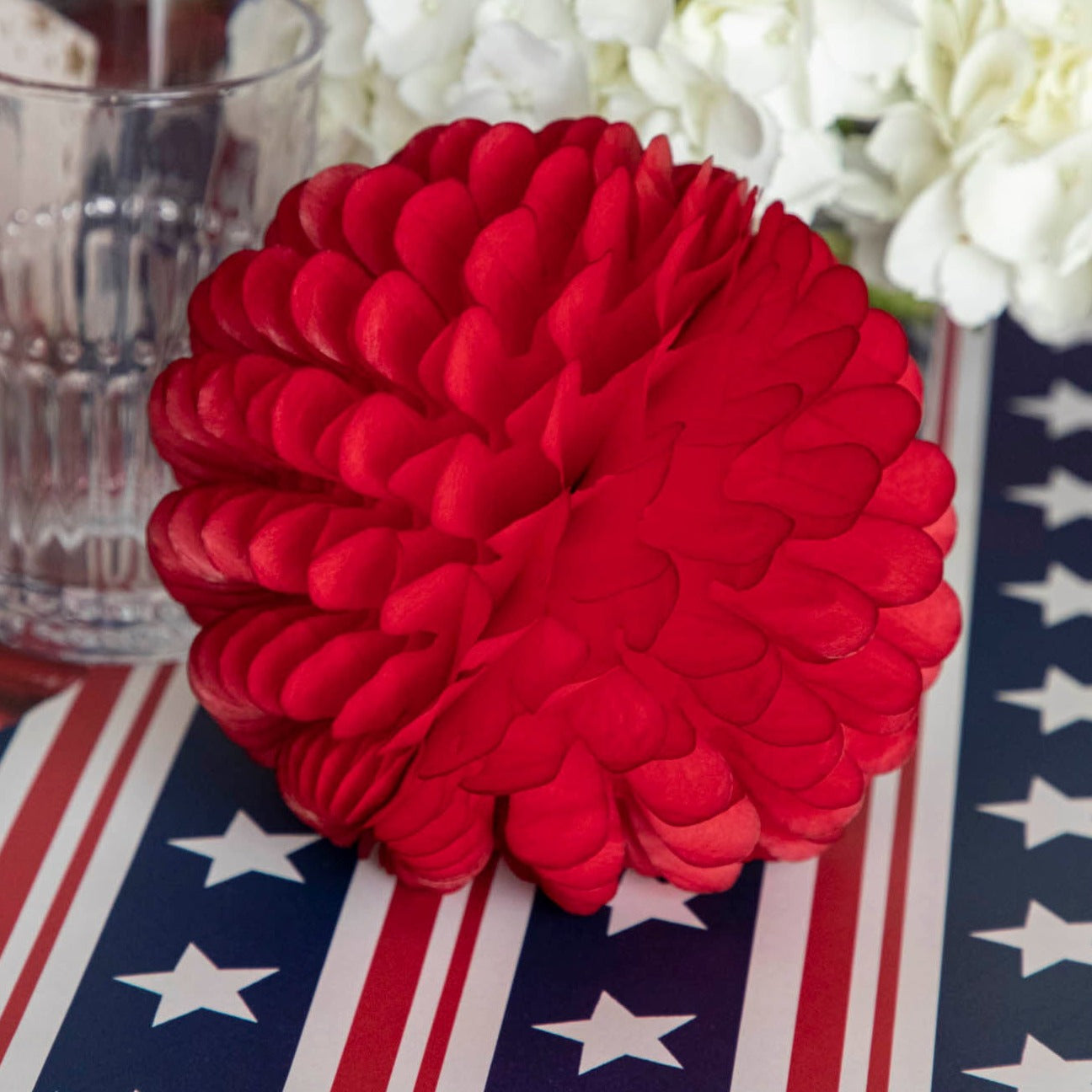 A red flower on a Hester &amp; Cook Stars and Stripes Runner.