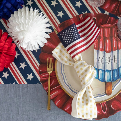 A table with a plate and a Stars and Stripes Runner by Hester &amp; Cook.