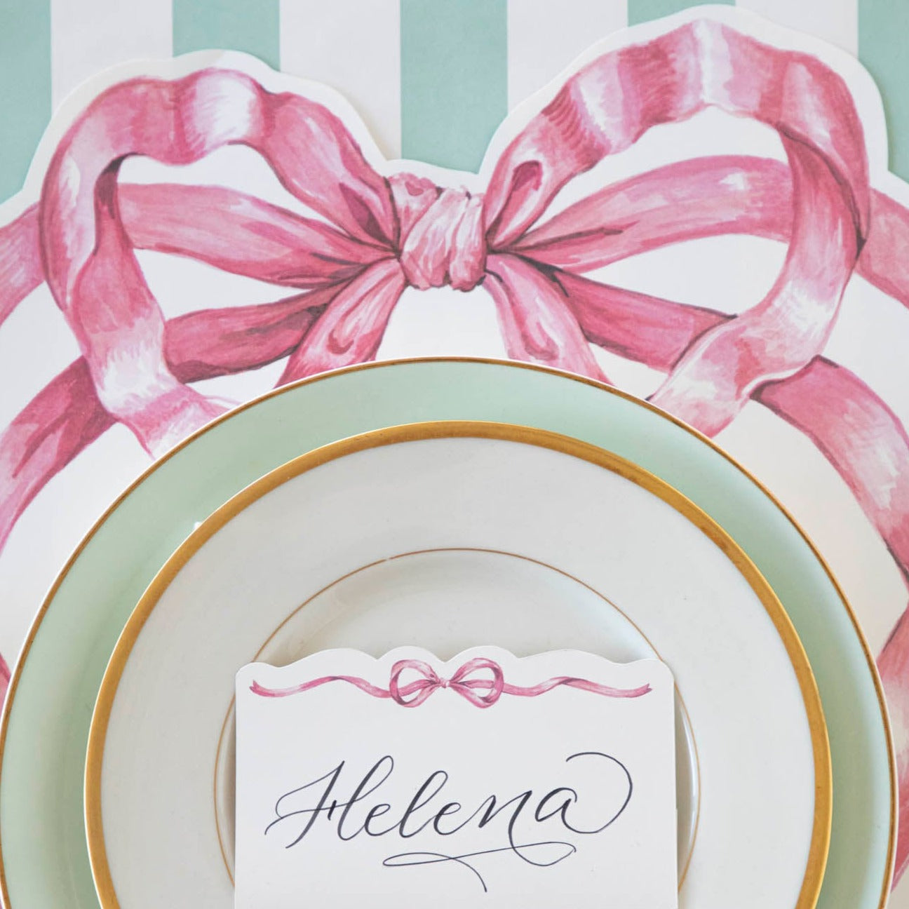 A whimsical Die-cut Pink Bow Placemat adorned with a Hester &amp; Cook pink bow.