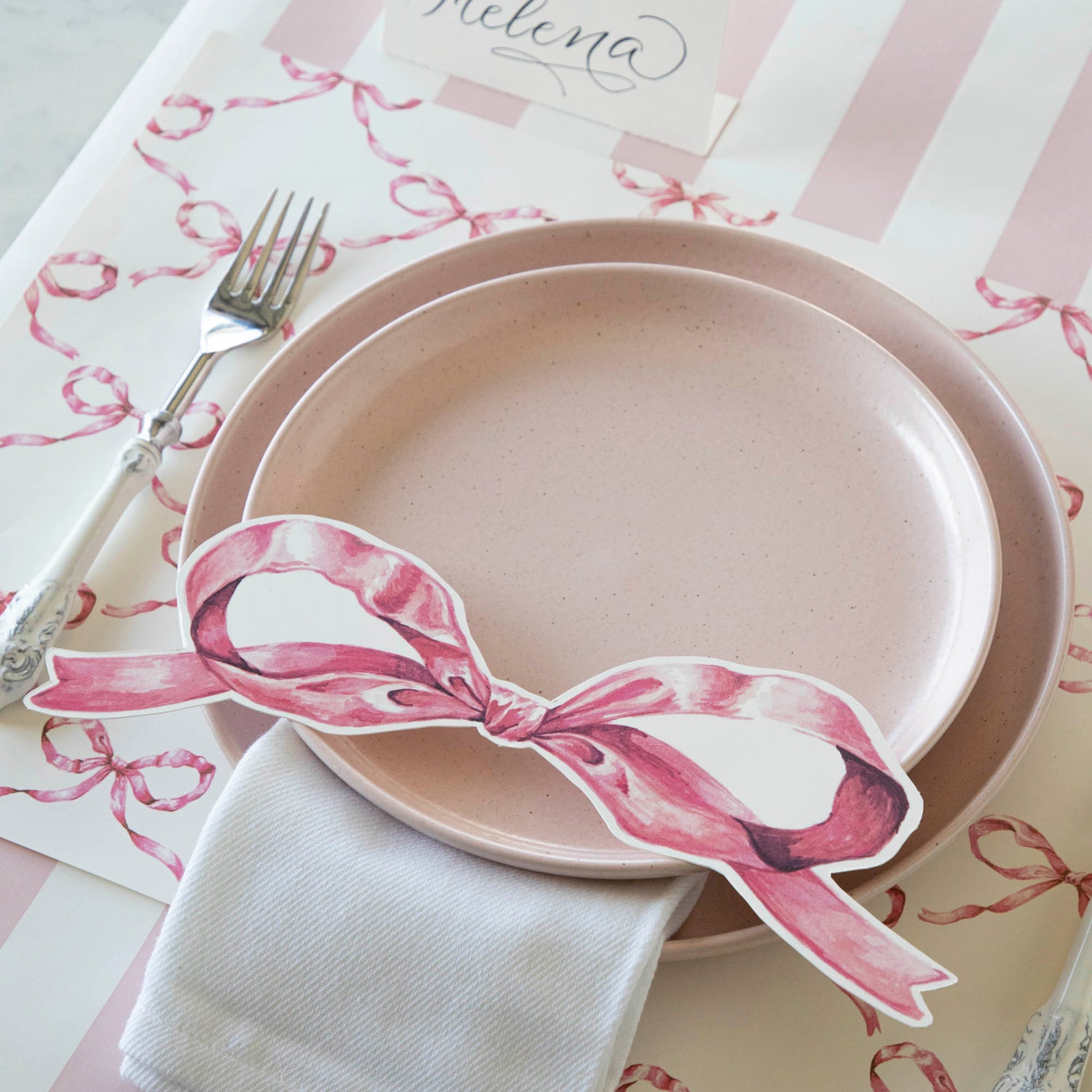 A versatile Pink Bow Table Accent featuring a plate and fork, adorned with a pink bow from Hester &amp; Cook.