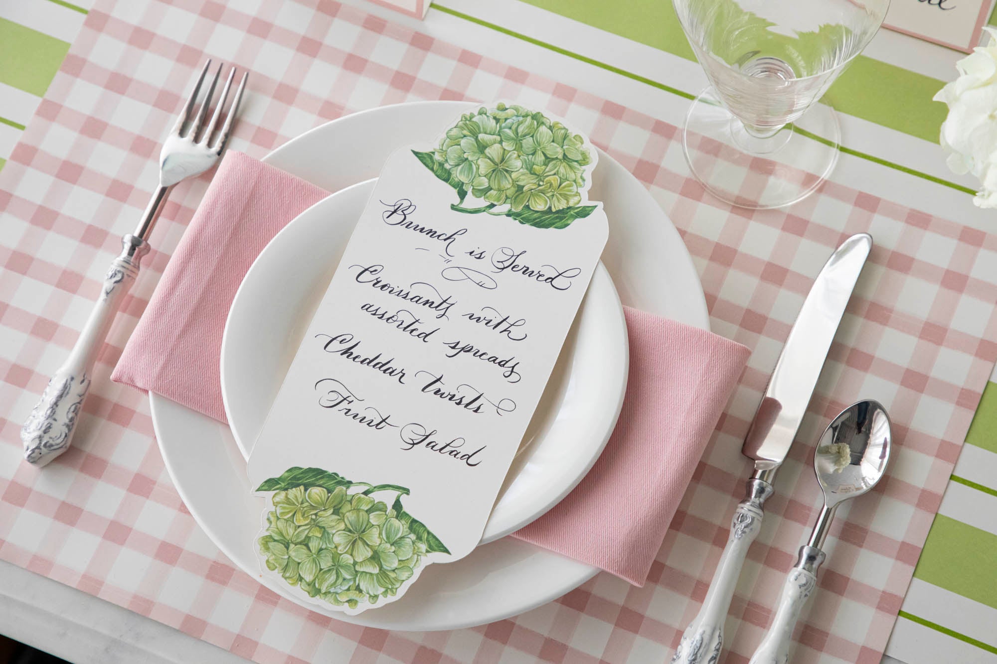 A pink and white place setting with hydrangeas on Pink Painted Check Placemats by Hester &amp; Cook.