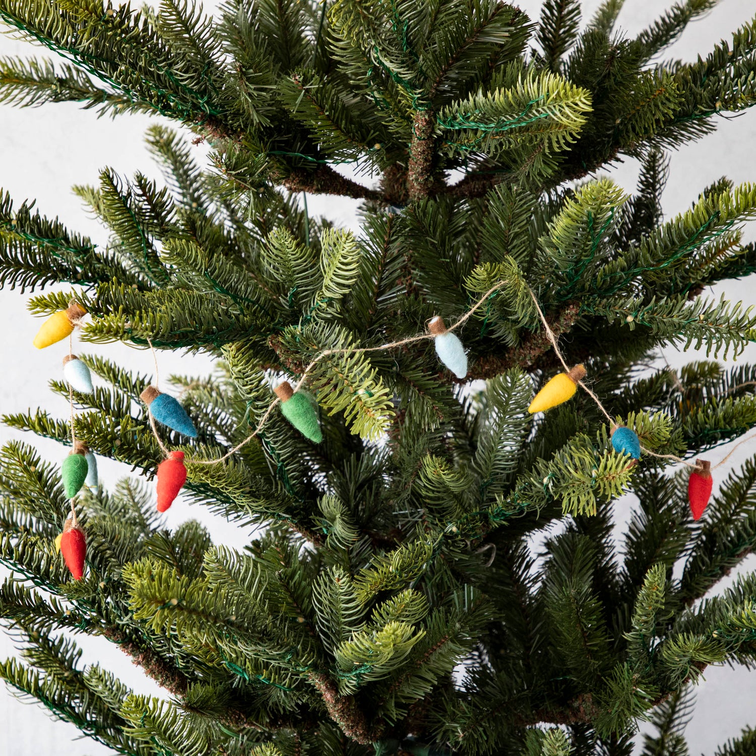 Felt String of Lights draped on a tree.