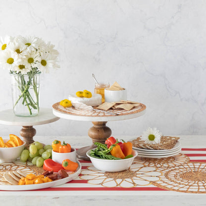 A vintage-inspired table adorned with plates, bowls, and flowers in Hester &amp; Cook Rattan Weave Serving Papers.