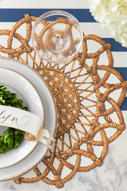 A table setting with a Die-cut Rattan Weave Placemat by Hester &amp; Cook and napkin.
