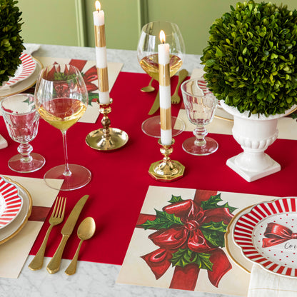 An elegant, Christmas themed table setting with the Red Flocked Runner underneath the Christmas Present Placemat.