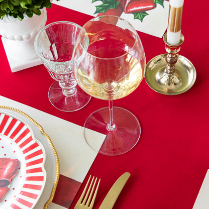 An elegant table setting on top of the Red Flocked Runner.