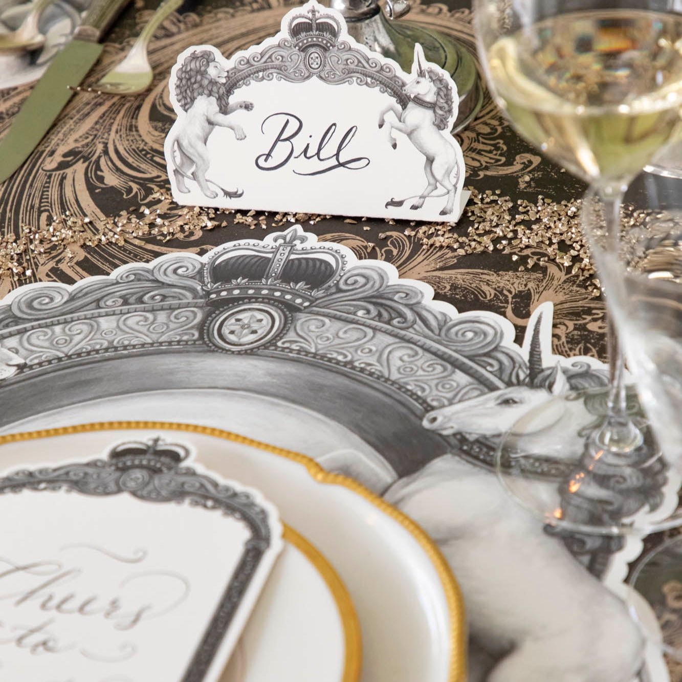 Regal Crest Place Card with &quot;Bill&quot; written on it, resting behind a place setting for one.