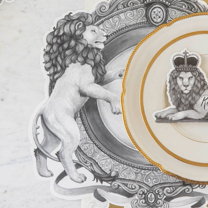 Die-cut H&amp;C Regal Crest Placemat on the Classic Gold Stripe Runner, with gold rimmed dinnerware on top.