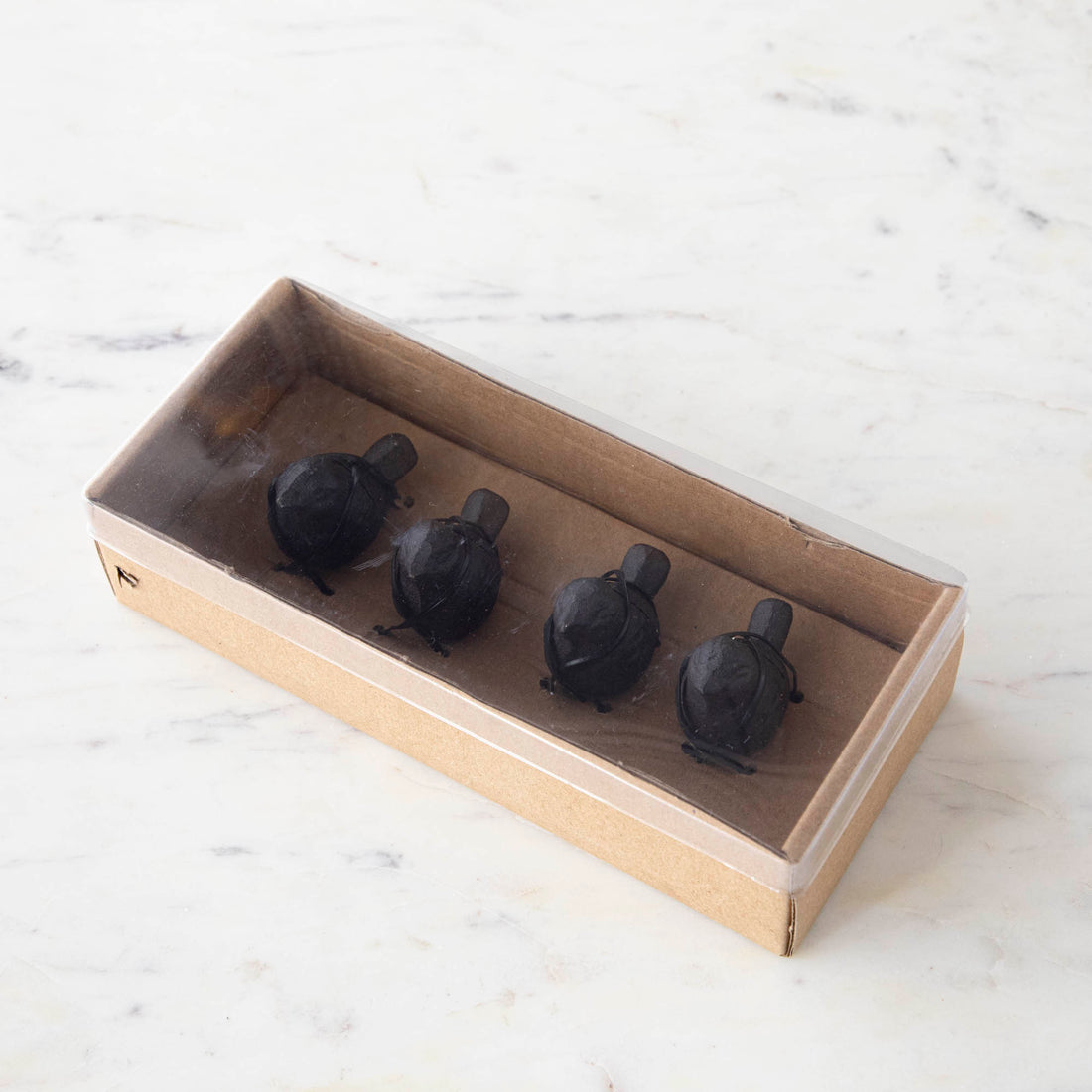 Four Cast Iron Songbird Place Card Holder sets of 4, by Park Hill, are arranged in a row on a wooden surface.