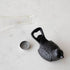 A small Park Hill Cast Iron Bird Bottle Opener with a rustic cast iron finish is sitting on a table.