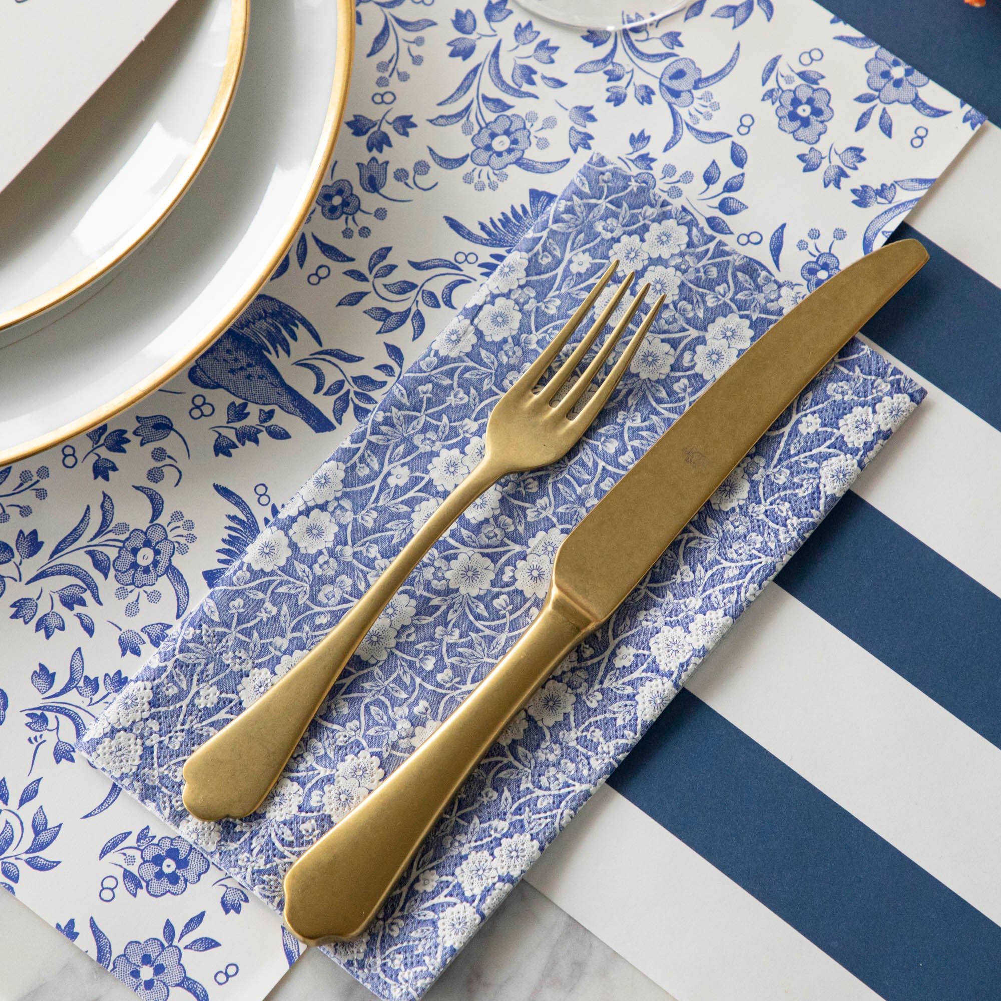 A Blue Calico Napkins place setting, exquisitely decorated with a fork and knife from Hester &amp; Cook.