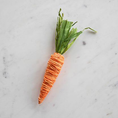 A Natural Carrot from Glitterville is sitting on top of a table setting.