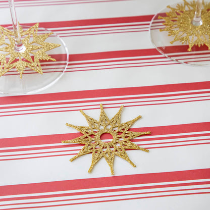 Two Stemware Snowflake Collars on wine glasses and one on a Peppermint Stripe Runner.