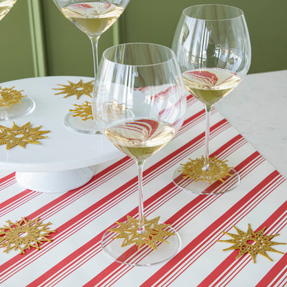 Wine glasses with Stemware Snowflake Collars around the base and other collars scattered on the table.