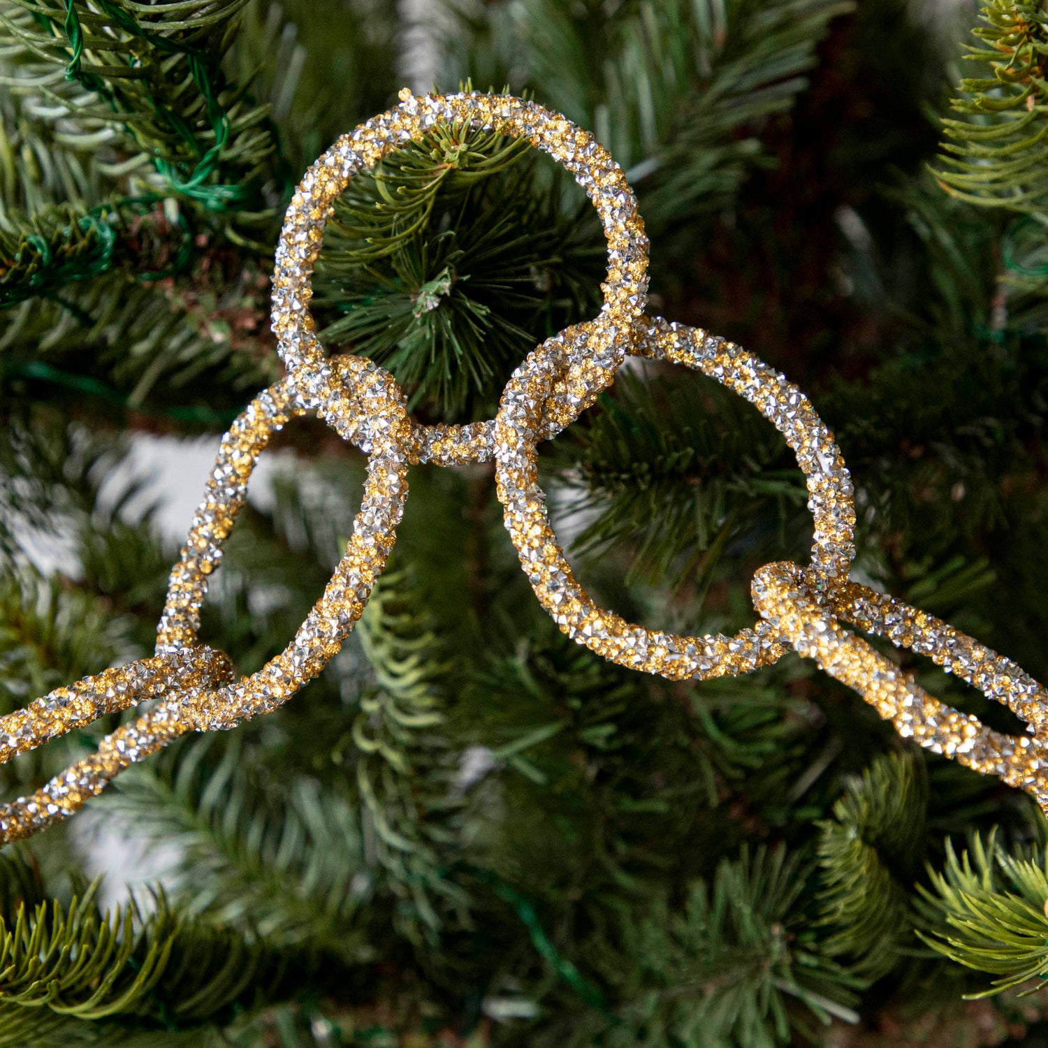 Gold &amp; silver sparkly ring garland hanging in tree