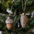 Close up of Acorn & Pinecone shaped ornaments in a tree