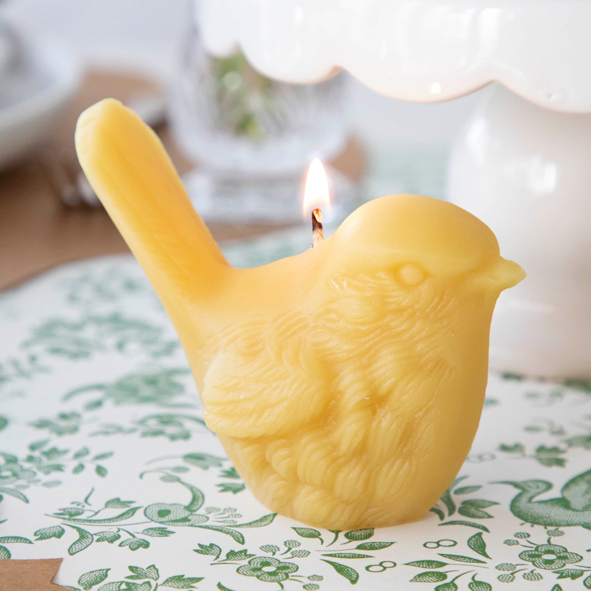 Two hand-casted Beeswax Songbirds Candles adorned with birds by Big Dipper Wax Works.