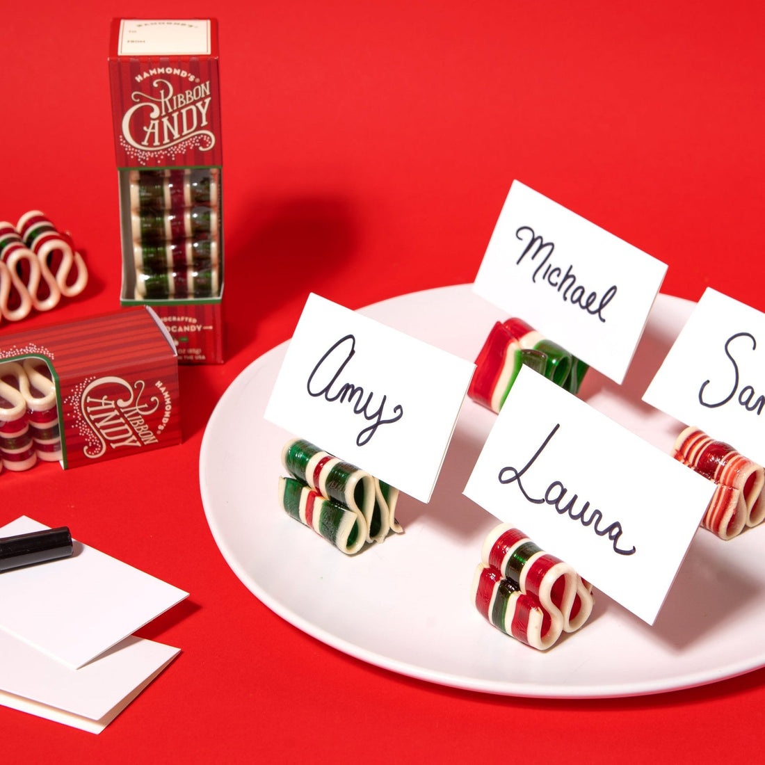 Candies with name cards on a red background
