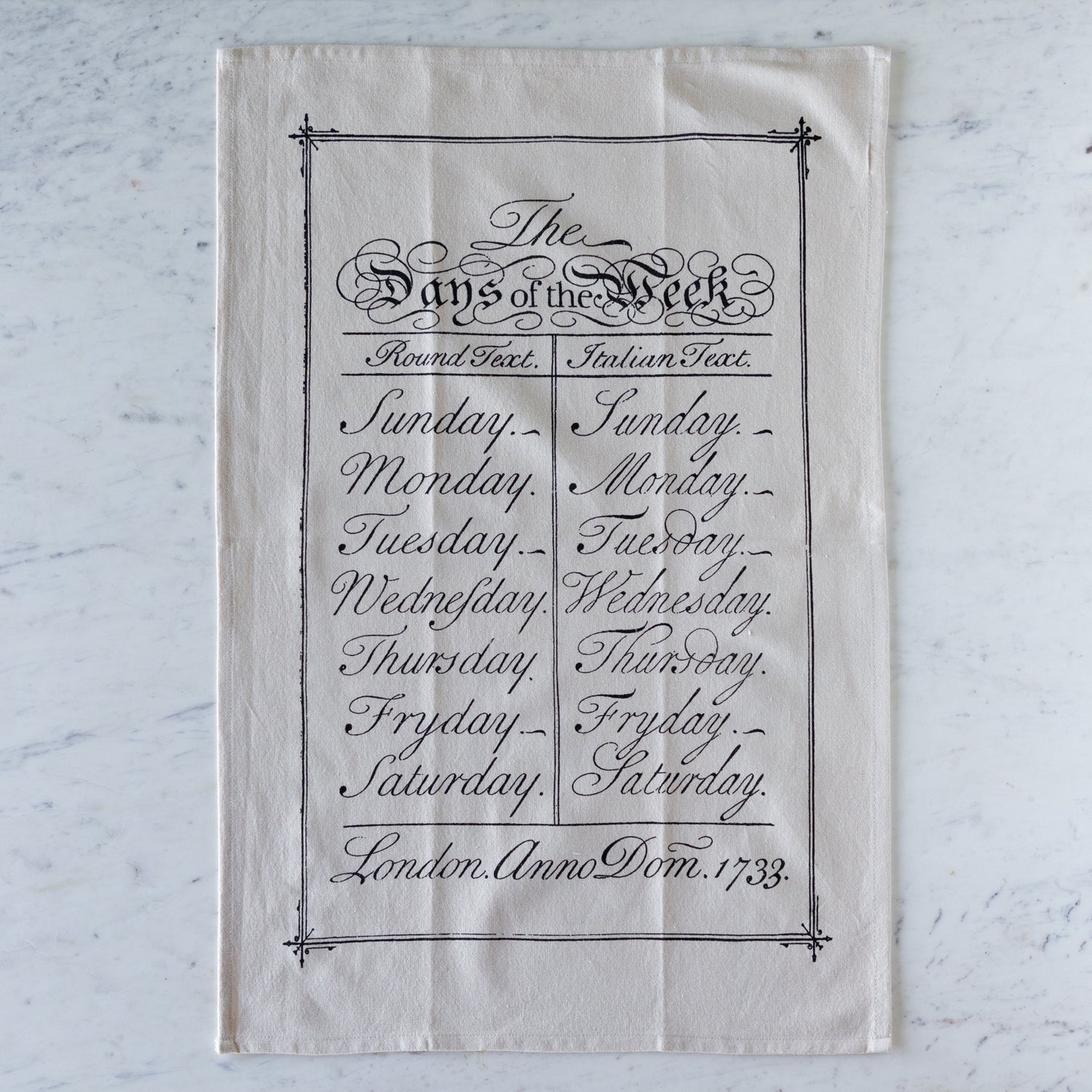 Days of the Week Tea Towel featuring the days of the week in black, cursive font.