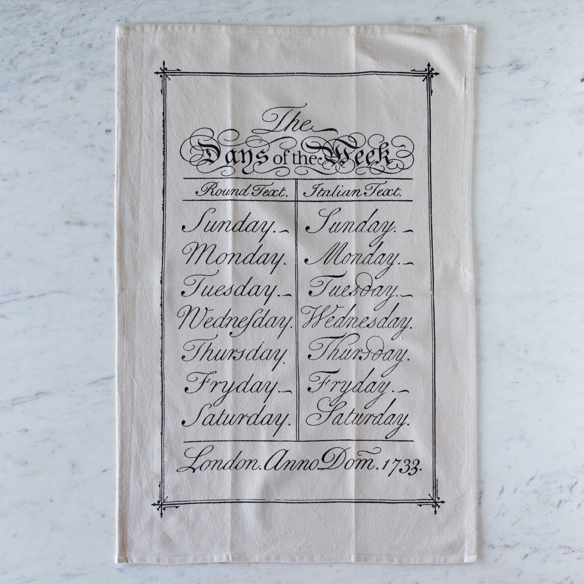 Days of the Week Tea Towel featuring the days of the week in black, cursive font.