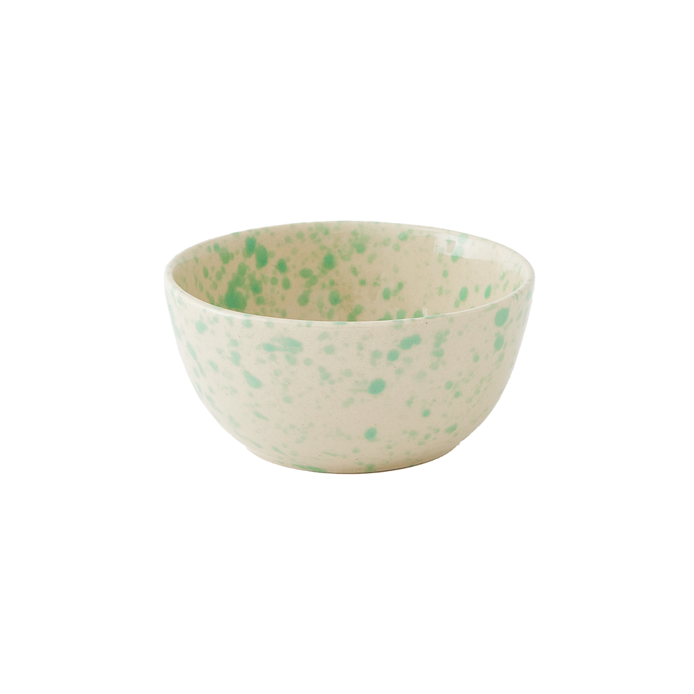 Speckled ceramic bowl with green spots on a white background