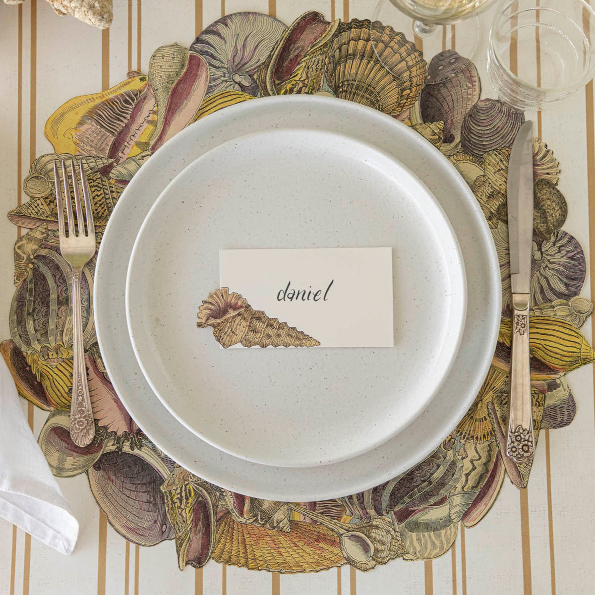 Die-cut Shell Wreath Placemat under an elegant place setting.