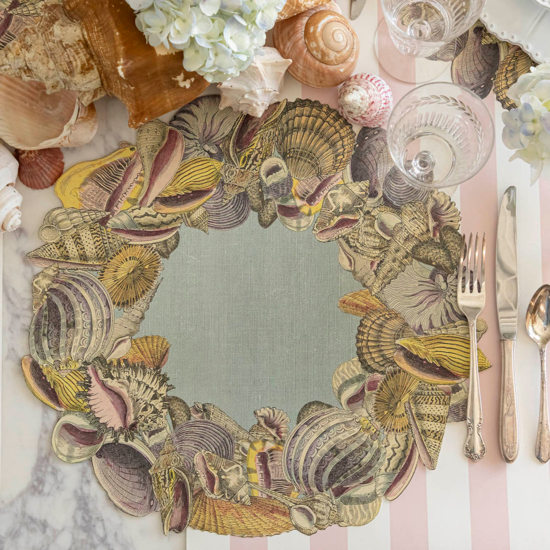 Die-cut Shell Wreath Placemat on a shell themed table setting.