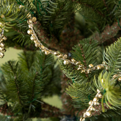 Festive bell garland draped on a tree.