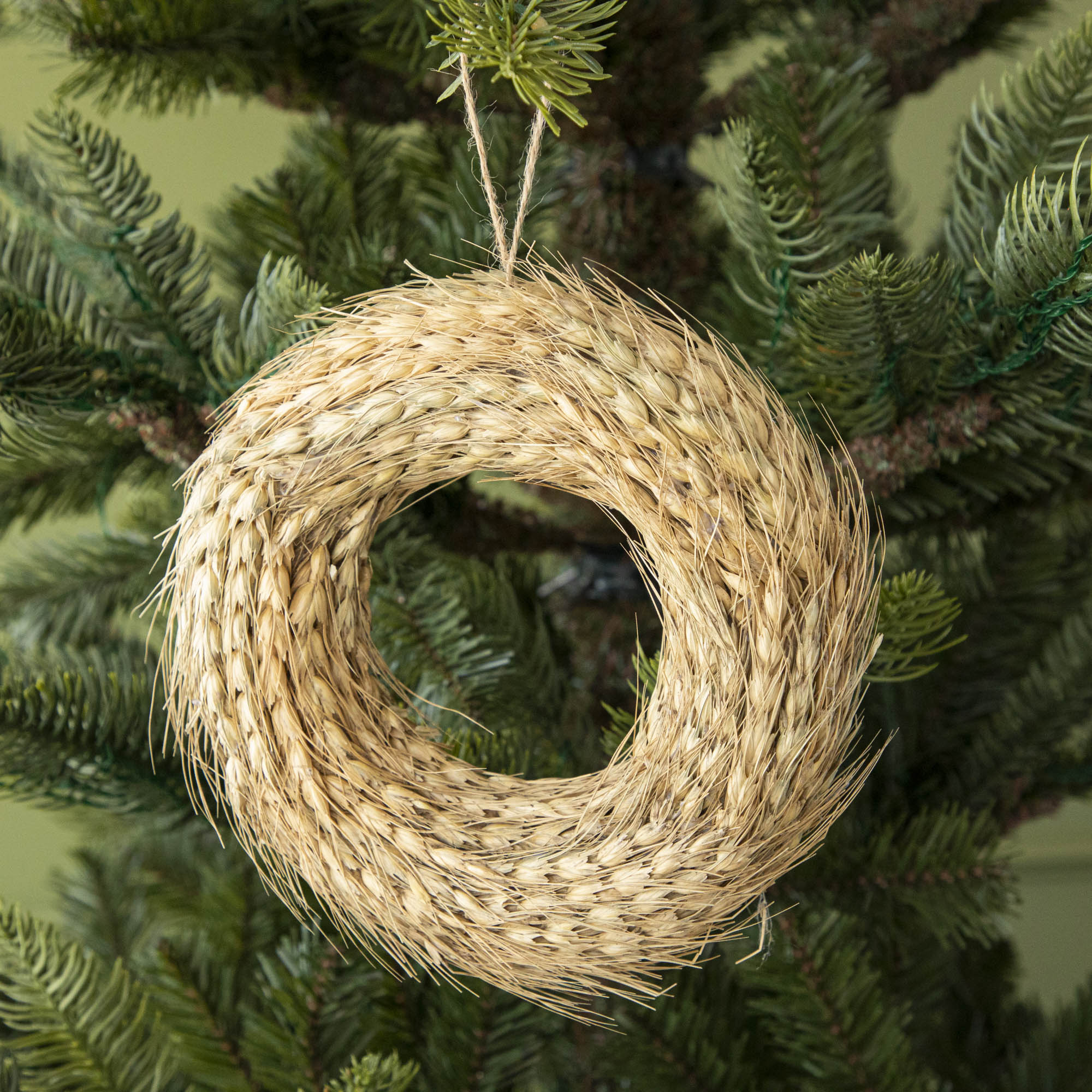 Wheat wreath ornament hanginng in tree